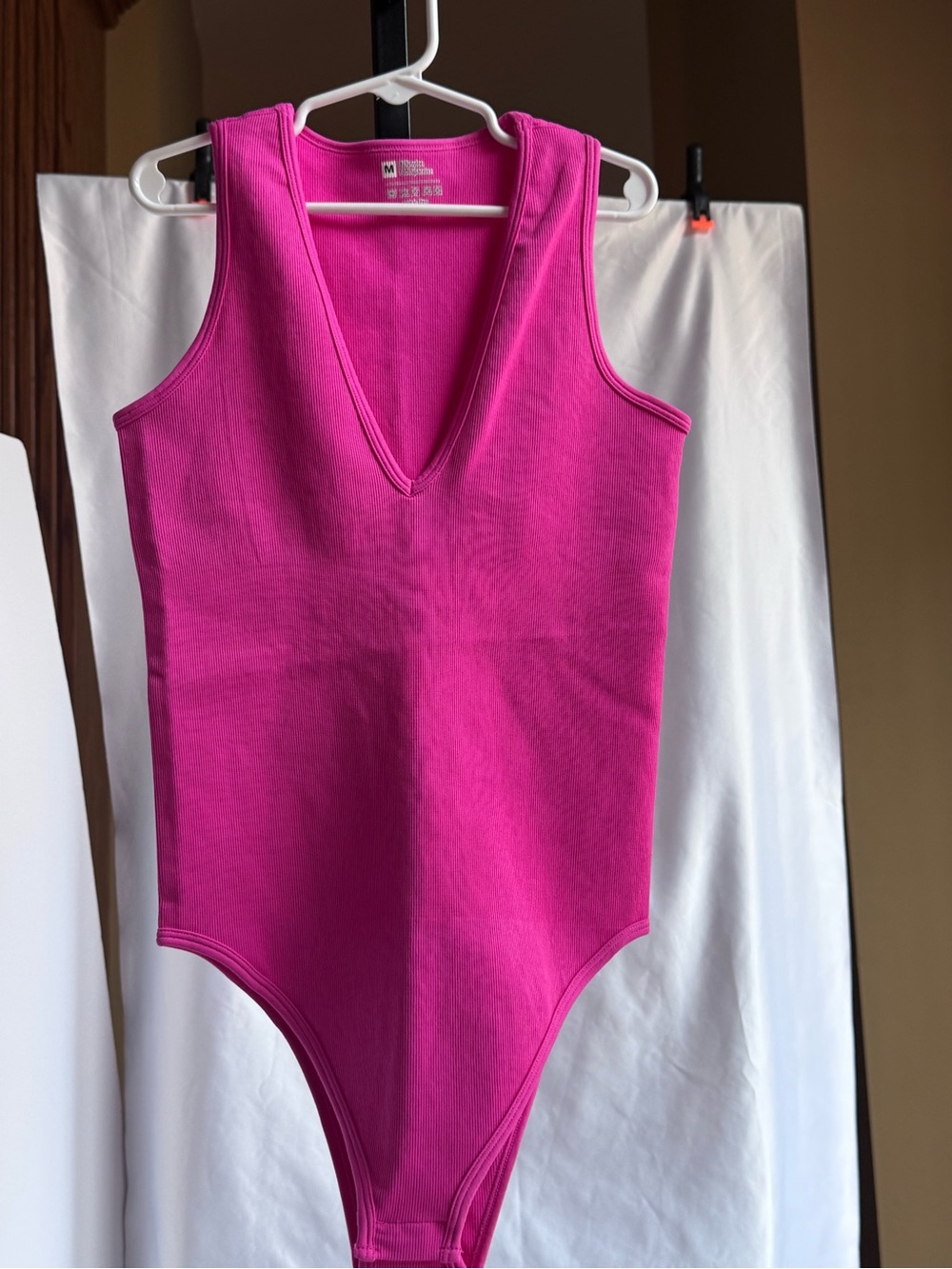 OQQ Ripped Sleeveless V‑Neck One‑Piece Bodysuit in Bright Pink